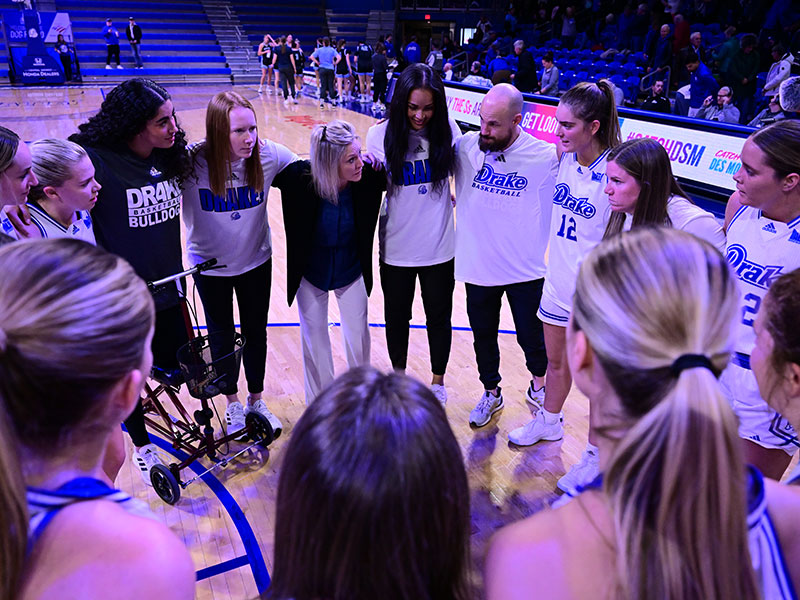 Drake's WBB team huddled on the court during a game.